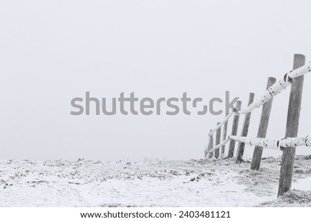 View of wooden fence covered with snow outdoors on winter day