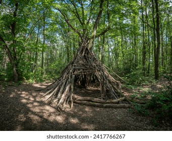 View of a wooden teepee in the forest Bois de Serre, Edge of the woods