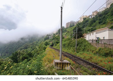 View of woods and houses around train tracks on cloudy and foggy day. Near the Lake of Albano, a quiet and bucolic countryside region near Rome. Located in the Lazio region, central Italy - Powered by Shutterstock