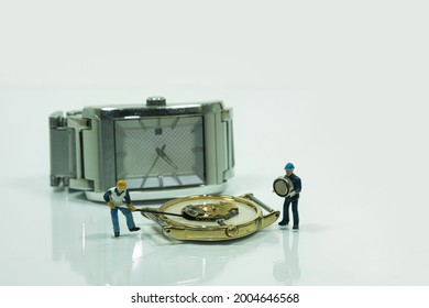View of a worker changing the battery on a watch. Wrist watch in the white background.
Concept: watch repair