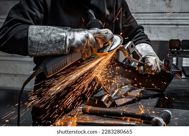 View of worker grinding a piece of metal, France - Powered by Shutterstock