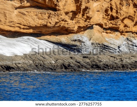 View of yellow cliffs and clear turquoise water in Playa Amarilla (Yellow Beach), situated at the foot of Montaña Amarilla (Yellow Mountain) on the Costa del Silencio in south Tenerife (Canary Islands, Spain).
