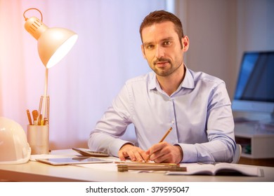 View Of A Young Attractive Architect Working Late At Office