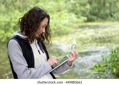 View Of A Young Attractive Biologist Woman Working On Water Analysis