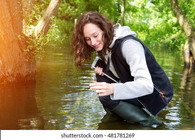 View Of A Young Attractive Biologist Woman Working On Water Analysis