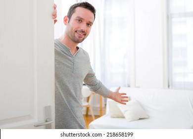 View Of A Young Attractive Man Welcoming You In His House