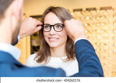 View Of A Young Attractive  Woman Testing New Glasses With Optician