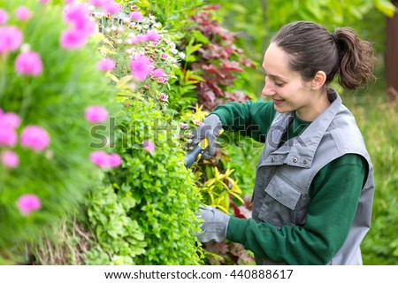 View of a Young attractive woman working in a public garden