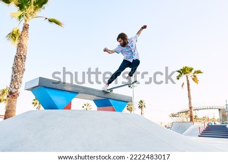 Similar – Image, Stock Photo Young bearded skater performing trick in skatepark