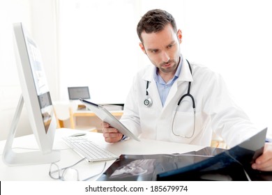 View Of A Young Doctor Using Tablet At Work