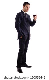 View Of A Young Man Holding A Red Glass Of Fine Wine Isolated On White Studio Background.