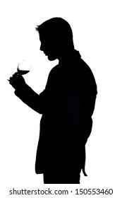 View of a young man holding a red glass of fine wine isolated on white studio background.