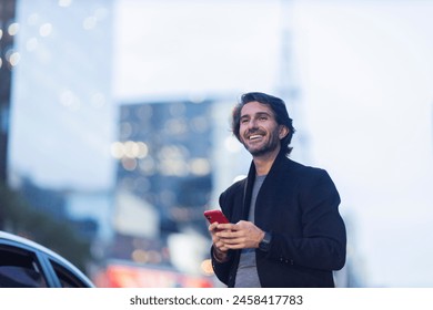 View of young man with smartphone at twilight with city view landscape in the background. High quality photo.  - Powered by Shutterstock