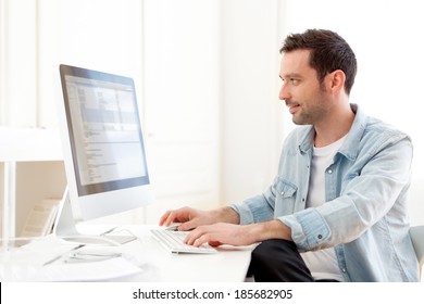 View Of A Young Relaxed Man Using Computer