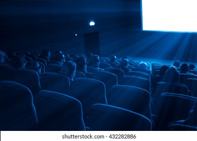 viewers watch a 3D motion picture in special glasses, blue toning