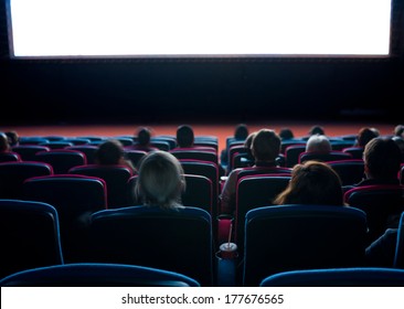 Viewers Watch Motion Picture At Movie Theatre, Long Exposure