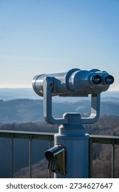 Viewing binoculars overlooking distant mountain landscape