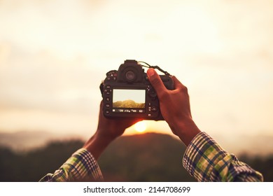 Viewing Natures Beauty Through A Lens. Closeup Shot Of An Unidentifiable Man Taking A Photo On A Camera Outside.