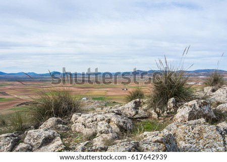 A viewpoint at the hill with a view to fields and mountains near Consuegra Castilla La Mancha, Spain.