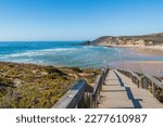 Viewpoint on blurred wooden pathway to sea and sand of Amoreira beach, Aljezur PORTUGAL