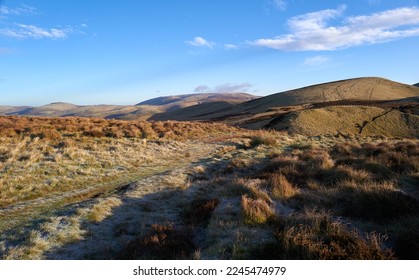 Views of The Cheviot in the distant centre with Windy Gyle on the right on a sunny winters morning in the Northumberland Cheviot mountains at sunrise, UK. - Shutterstock ID 2245474979