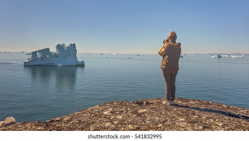 Views of Disko Bay and huge iceberg near village of Oqaatsut on a sunny day - Greenland - Powered by Shutterstock