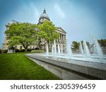 Views of the Illinois State Capitol Building in Springfield, Illinois, USA. Beautiful ornamental water fountain sprays and splashes in front of the building.