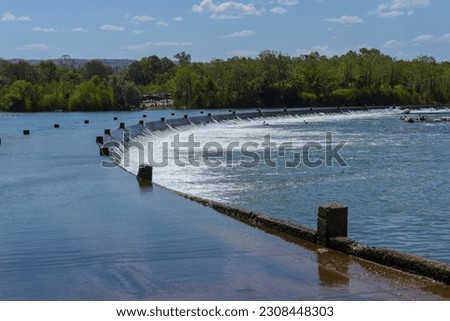 Views of the Ivanhoe Crossing with the river water flowing continuously over the road near Kununurra in Western Australia