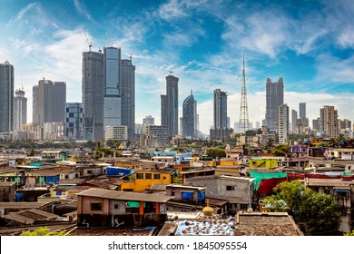 Views of slums on the shores of mumbai, India against the backdrop of skyscrapers under construction