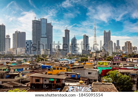Views of slums on the shores of mumbai, India against the backdrop of skyscrapers under construction