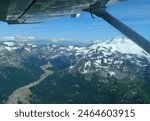 views of tidal flats, glaciers, and mountain peaks  on a sunny sumer day while flying to chinitna bay in lake clark national park, near homer , alaska       