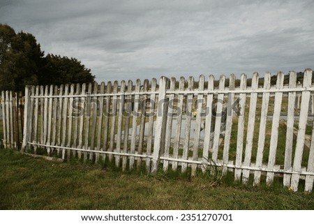 Views of wooden picket fence and gateway to Uniting Church cemetery.