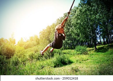 Vignetting Photo of Kid Bungee jumping in the Summer Forest