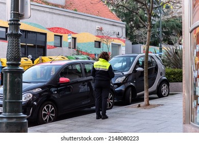 Vigo, Spain - December, 17, 2022 : Parking Enforcement Officer Observes An Illegally Parked Vehicle