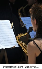 Vigo, Vigo, Spain - May 17th 2022: Girl Playing Saxophone In Outdoor Orchestra Band Environment