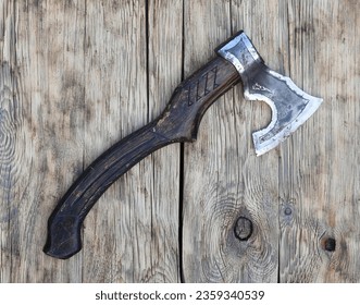 viking ax on old wooden background