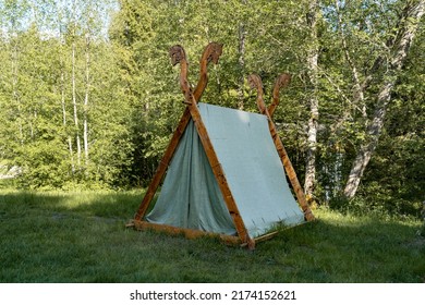 Viking camp by the river. Couple of  stylish tents on the grass. Located in the viking village. Tranditional nordic viking camping style. Sunny summer day in Estonia. High resolution image