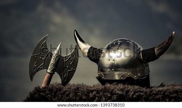 Viking helmet with axe on fjord shore in Norway.\
Tourism and traveling\
concept