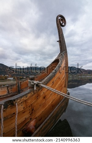 Viking ship with carved dragon head.