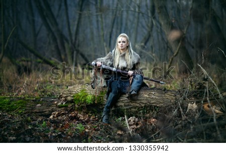 Viking woman warrior with a sword in her hands, in the woods. Authentic recreation of Norse mythology, myths of the North Germanic peoples. Book Cover