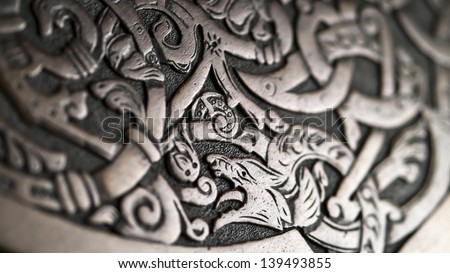 Viking wood carving depicting a wolf or a dragon, low depth of field