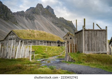 Vikings longhouse and village surrounded by a palisade, mountains in the background, Stokksnes, Iceland