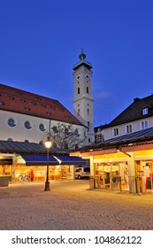 Viktualienmarkt, the famous "Victuals Market" in the centre of Munich, Germany.  In the background the "Church of the Holy Ghost". - Shutterstock ID 104862122