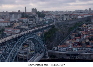 Vila Nova De Gaia, Portugal - 07.21.22: European Landscape With A View Of The City Of Porto In The Background - Dom Luís I Bridge Over The Douro River Connects Porto To Vila Nova De Gaia.