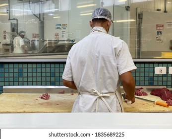 Vila Velha, Espirito Santo, Brazil - 10/17/20 - Employee Cuts Meat At The Butcher Shop Inside The Supermarket