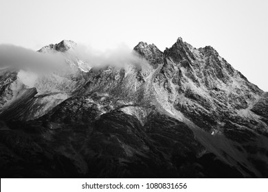 Villa Cerro Castillo, Región De Aysén / Chile - 03 17 2018: Black And White Mountain Range In Patagonia With Some Clouds Just Slightly Touching It.