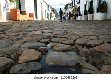 Villa De Leyva / Colombia - Circa 2017: People Walking In The Historical Cobblestone Streets Shot From Below, Low Angle