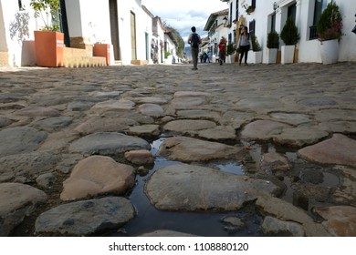 Villa De Leyva / Colombia - Circa 2017: People Walking On The Cobblestone Streets Of The Town, Shot From Below