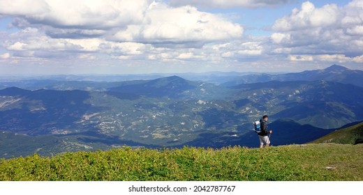 Villa Minozzo, Reggio Emilia, Emilia Romagna, Italy - 02.09.2021: A hiker with a backpack on Mount Cusna on the ridge of the park reserve MAB Appennino Tosco-Emiliano