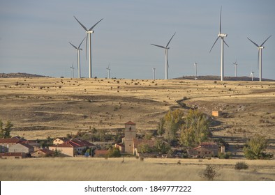 Villacadima, uninhabited town in the province of Guadalajara next to an immense wind farm with huge turbines. - Shutterstock ID 1849777222
